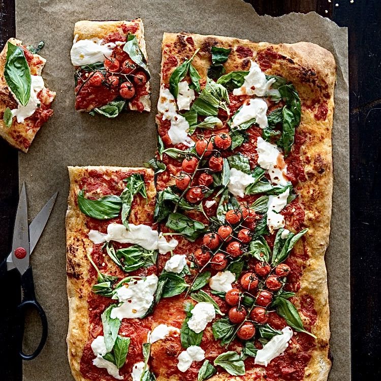 Roman tray pizza cut into slabs on parchment